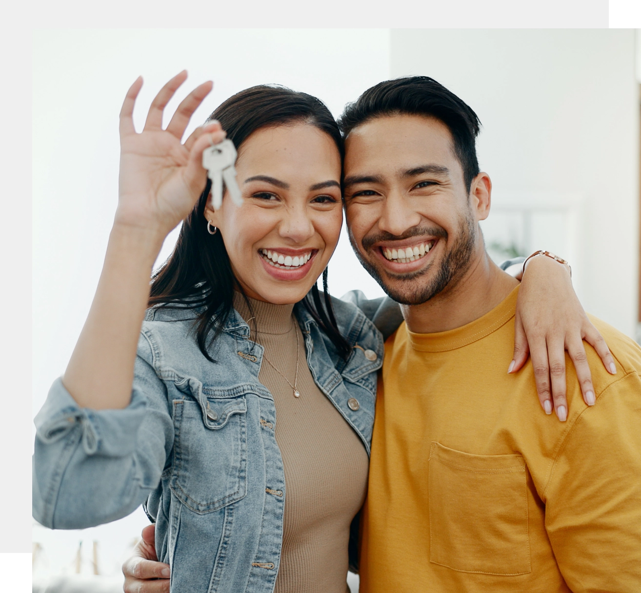 Happy couple holding house keys.