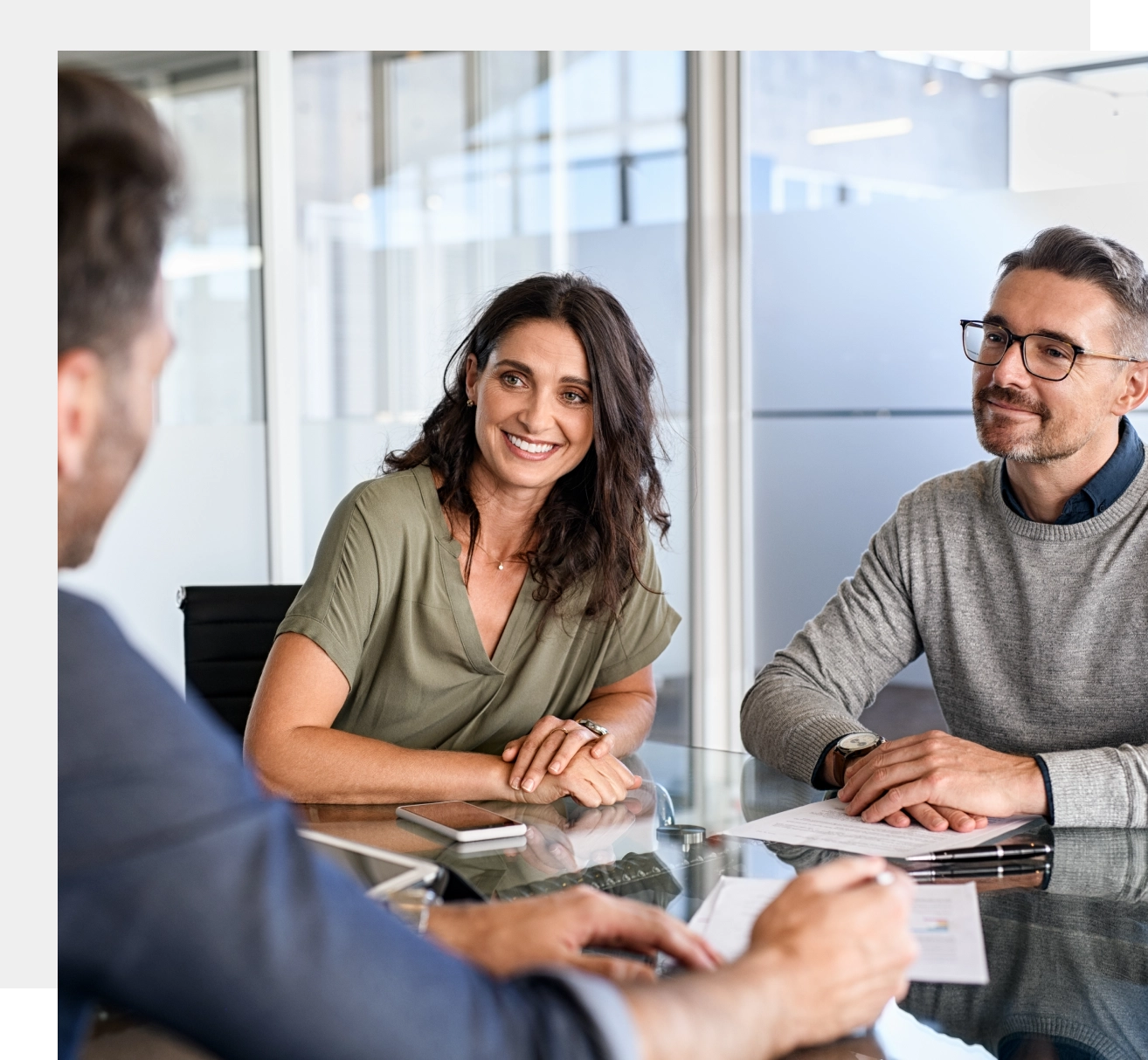 Happy couple meeting with financial advisor.