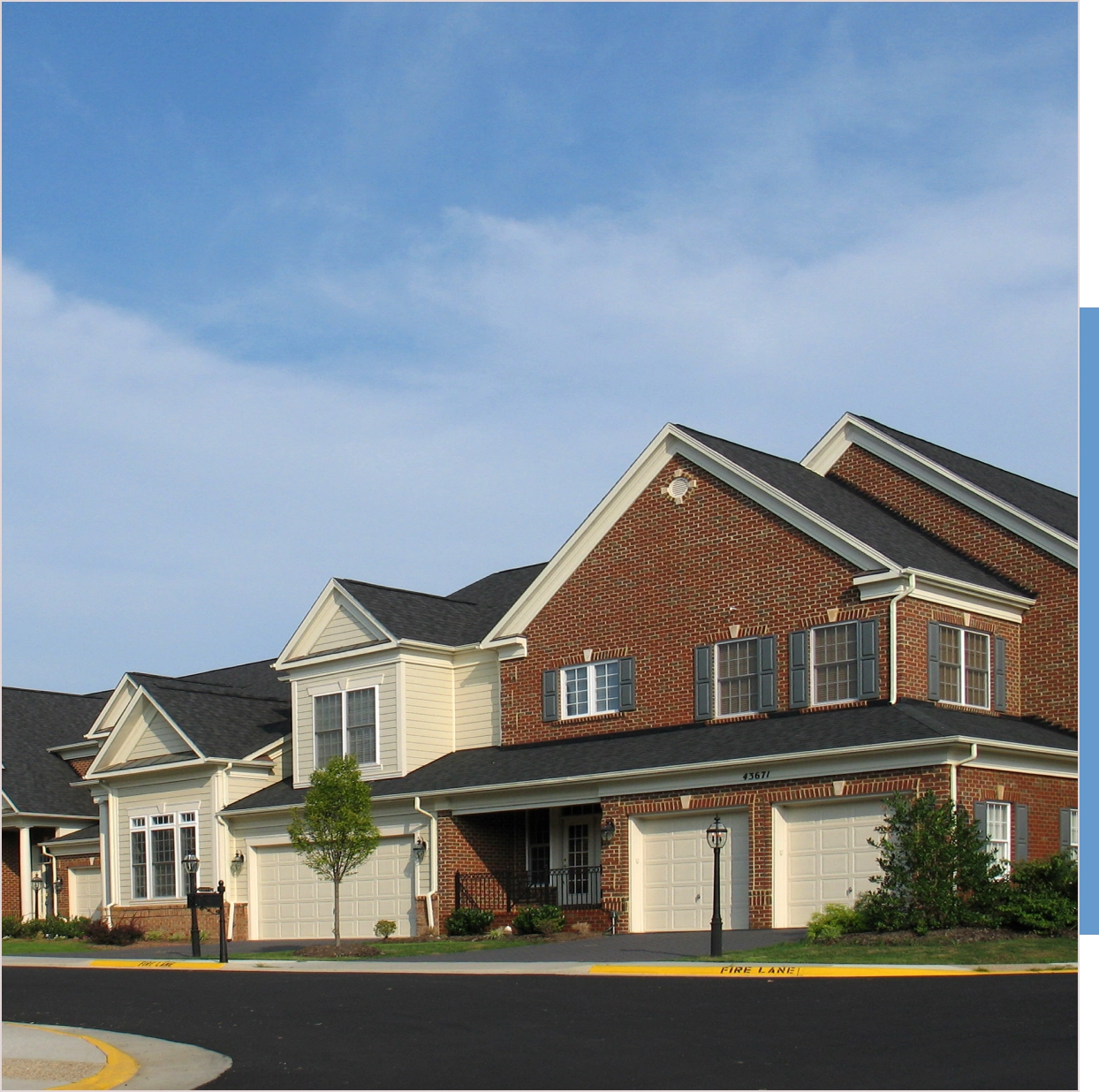 Brick townhouses, sunny day, fire lane.